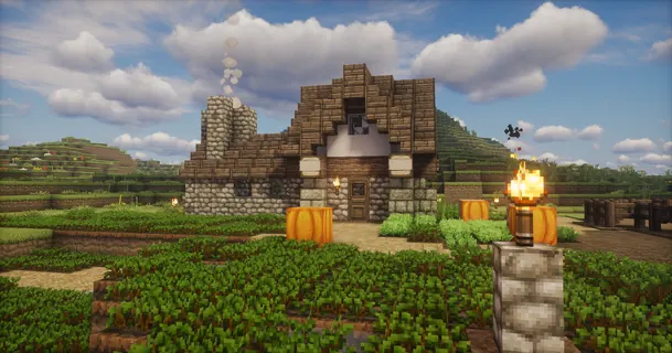 Stone cottage with pumpkins and smoking chimney