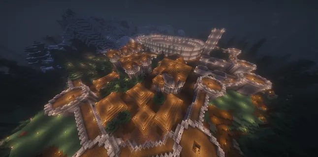Night aerial of a lantern-lit walled town with a colosseum